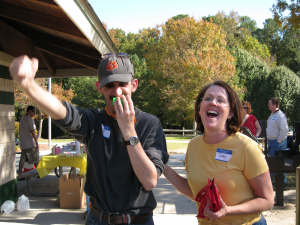 Man and woman at a picnic laughing and having fun.