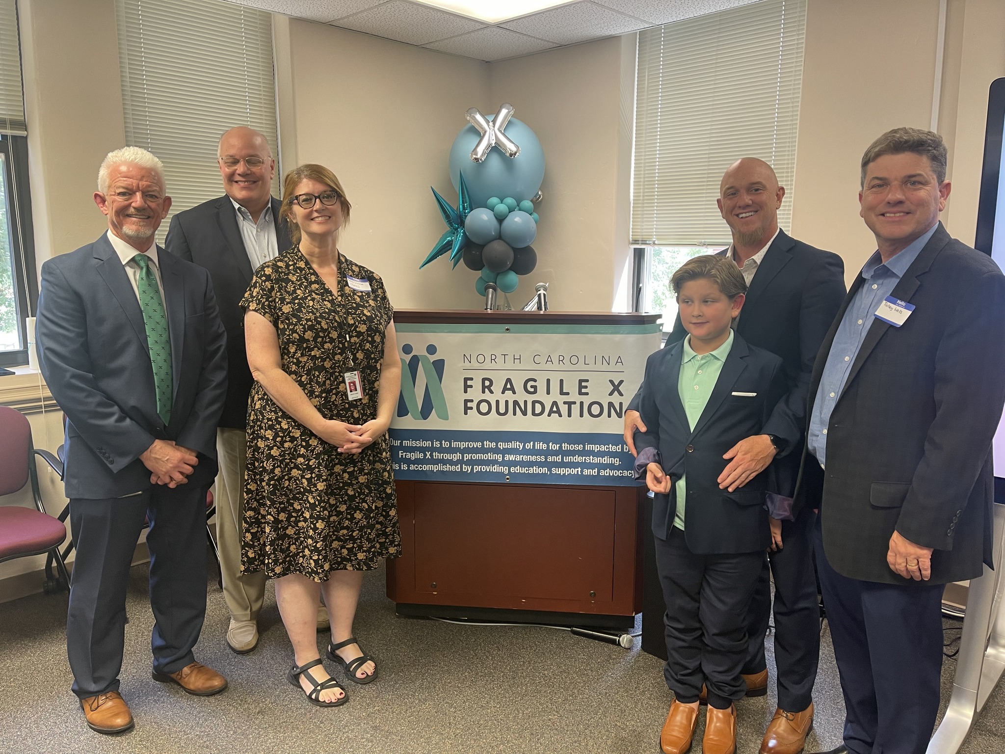 Steve Strom, Deputy Secretary Mark Benton, DMH/DD/SUS Director Kelly Crosbie, Parent David Tillman and his son Miles, and Talley Wells were a part of the Fragile X Community Conversation.