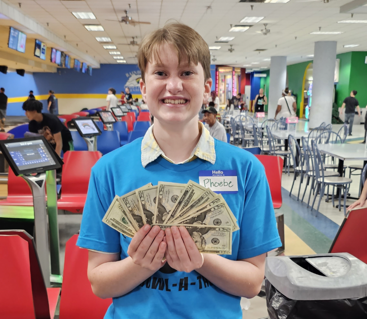 Phoebe Field, winner of the 50/50 raffle, shows off his prize money.
