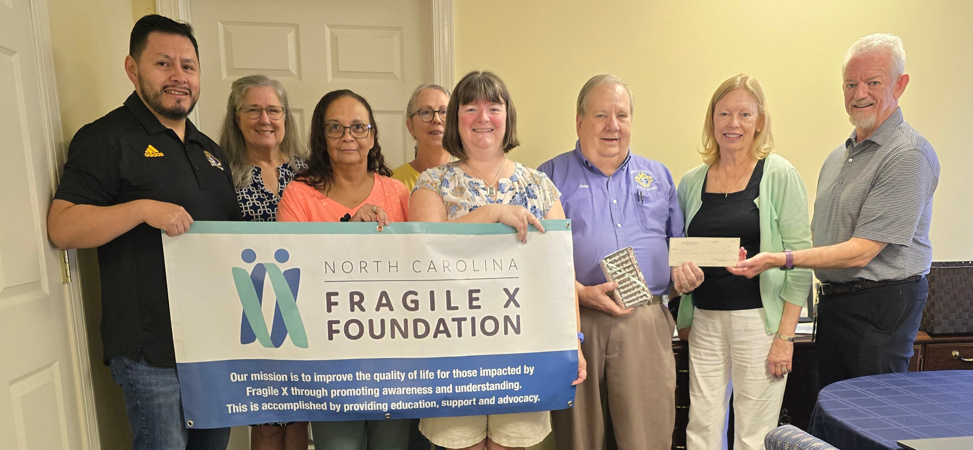 Juan Pablo Molliendo, Renée Duffee Clark, Allison Taylor, Deb Burgess, Diane Upshaw, John Gouldie, Ave Lachiewicz and Steve Strom with Knights of Columbus donation.