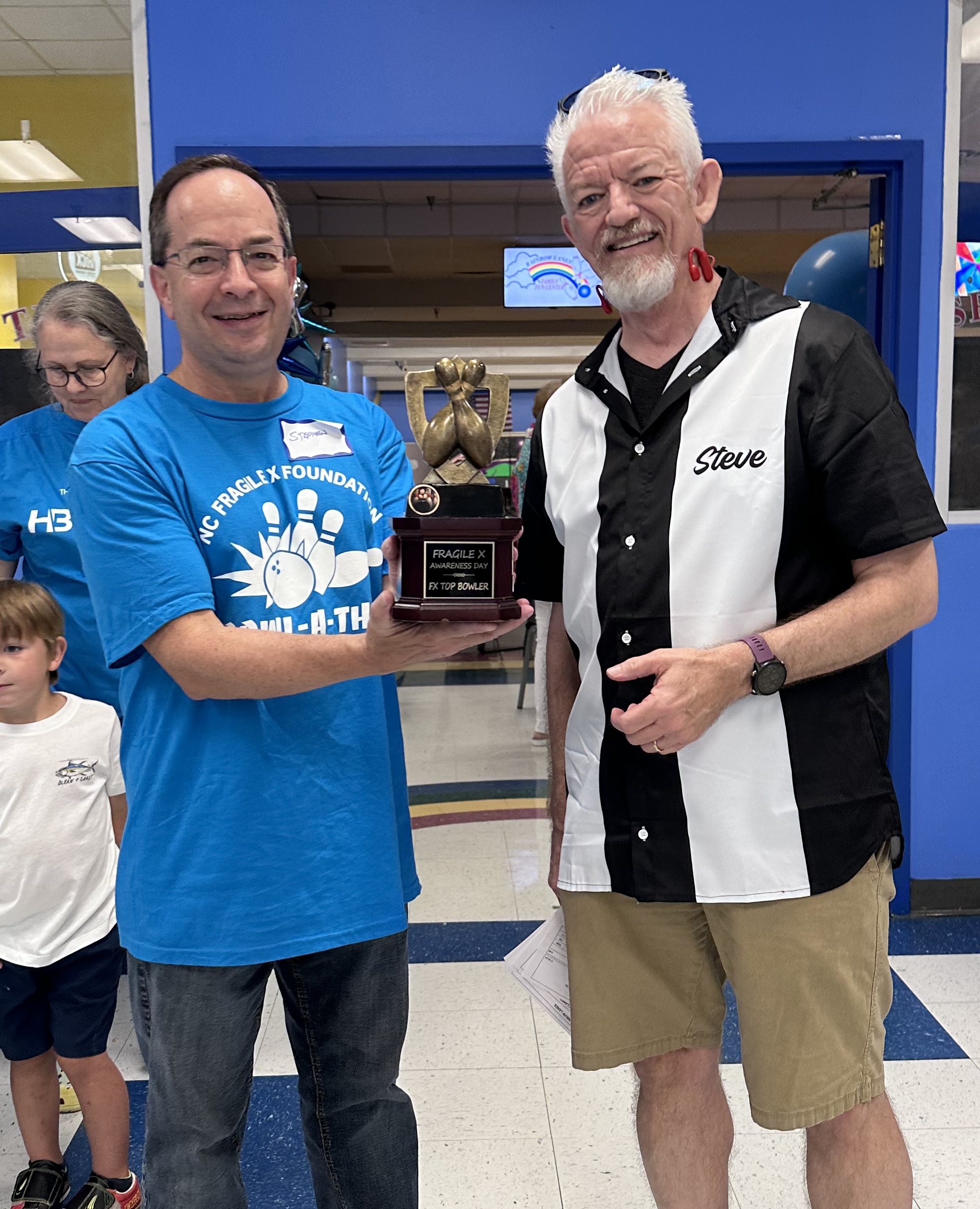 NCFXF President Steve Strom presents 2024 bowling trophy to Stephen O'Quinn.