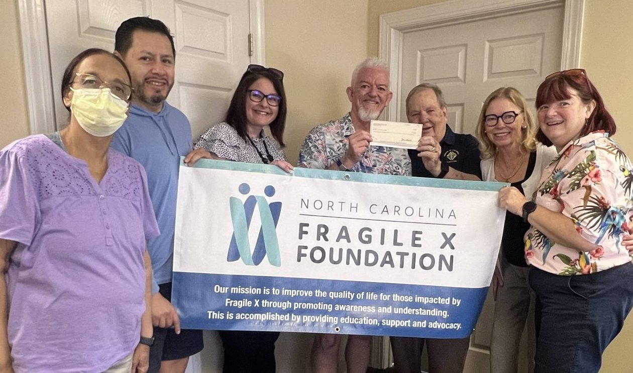 John Gouldie of the Knights of Columbus presents a check to Steve Strom (center), flanked by Board Members (l to r) Allison Taylor, Juan Mollinedo, Brittney Miller, Dr. Ave Lachiewicz and Diane Upshaw.