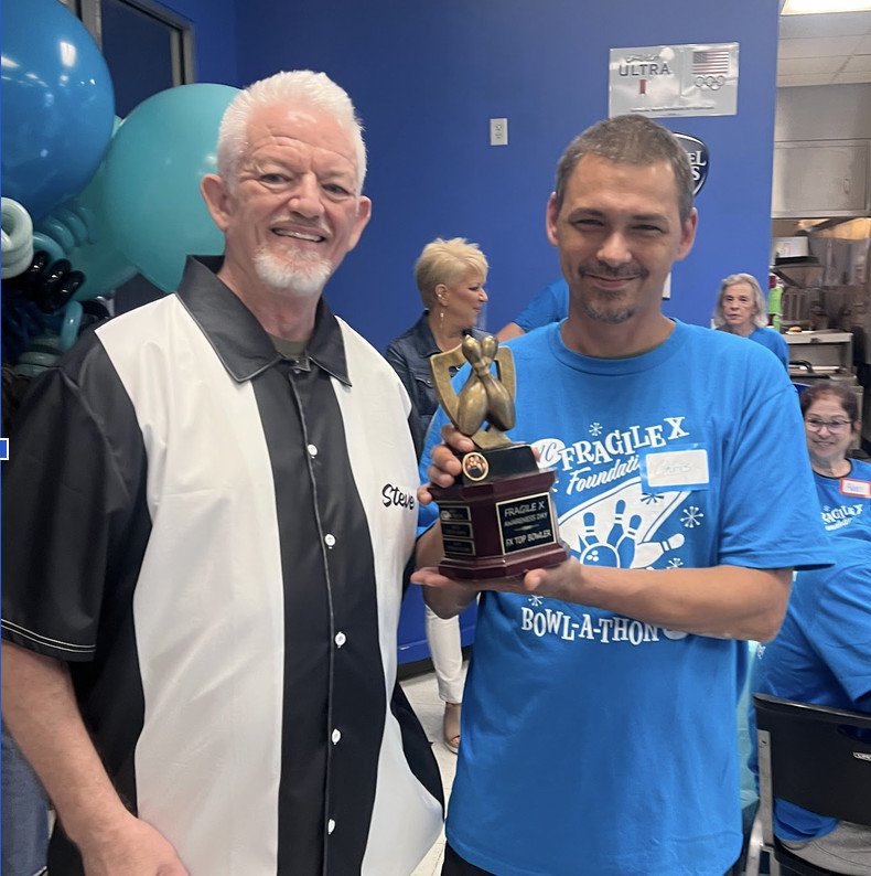 Steve Strom presents the 2026 Top Bowler Trophy to Chris Hickman.