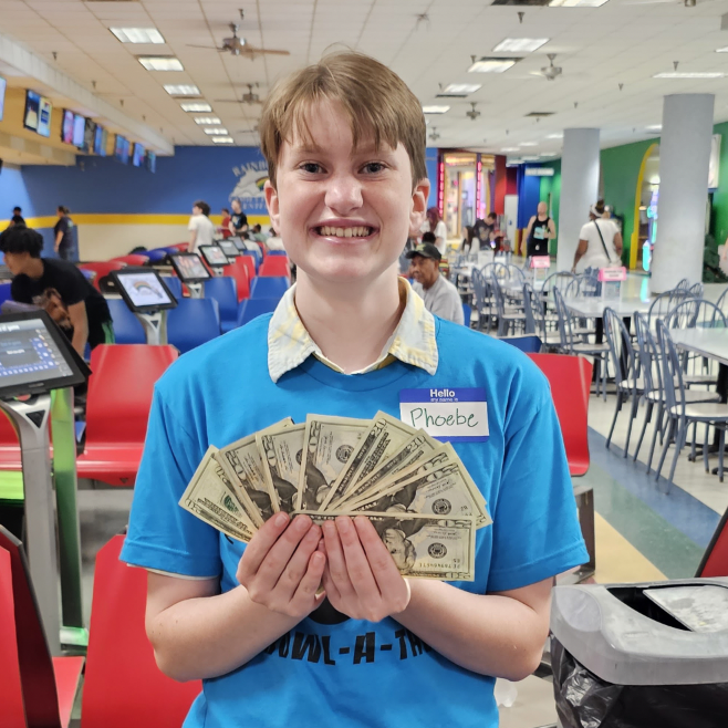Phoebe Field, winner of the 50/50 raffle, shows off his prize money.