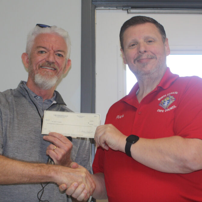 President Steve Strom (L) accepted a generous donation from  the Knights of Columbus and their state treasurer, Rick Lewis (R) at the 2022 picnic.