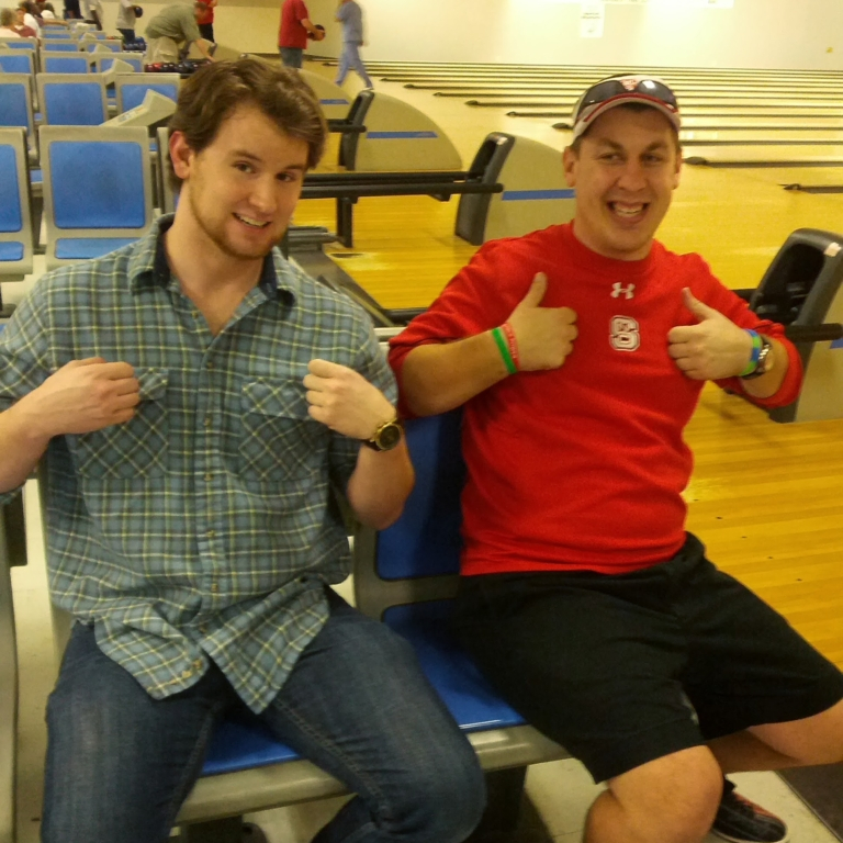 Two attendies of the NC Fragile X Bowl-A-Thon giving two thumbs up!